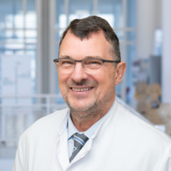 Porträt von Univ-Prof. Dr. med. Dirk Schadendorf im weißen Kittel in der Dermatologie der Universitätsmedizin Essen